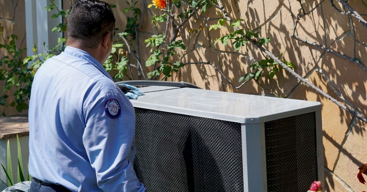 Image of a technician performing HVAC maintenance